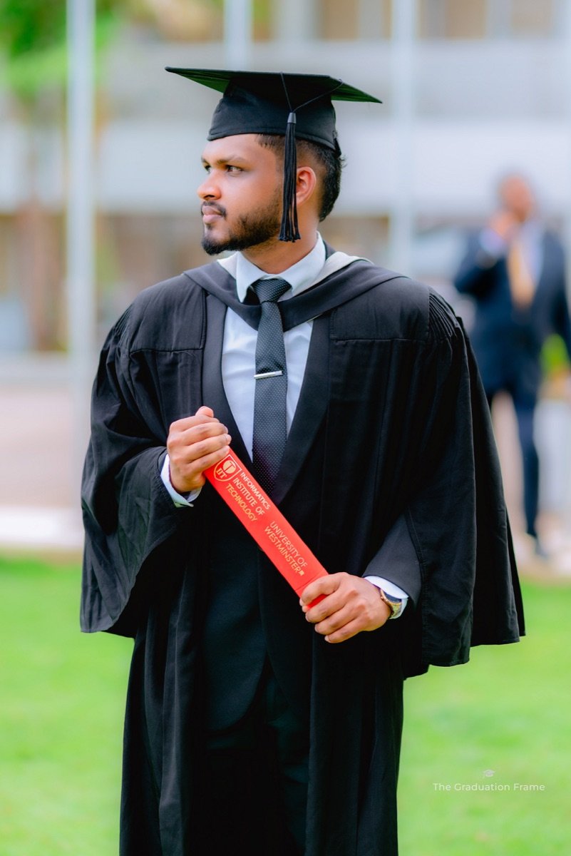 Lasith at his University of Westminster graduation, holding his diploma tube