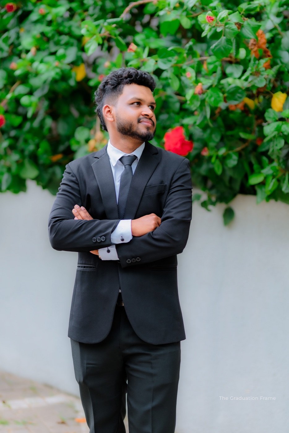 Lasith Chamika Viduranga in a suit, standing outdoors